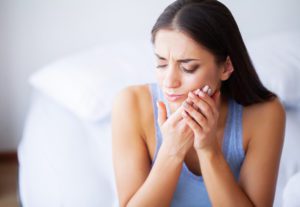 Tooth Pain. Woman Feeling Tooth Pain. Closeup Of Beautiful Sad Girl Suffering From Strong Tooth Pain. Attractive Female Feeling Painful Toothache. Dental Health And Care Concept.