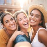 Three young smiling hipster women in summer clothes.