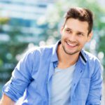 Image of happy young amazing man businessman posing outdoors outside.