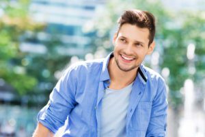 Image of happy young amazing man businessman posing outdoors outside.